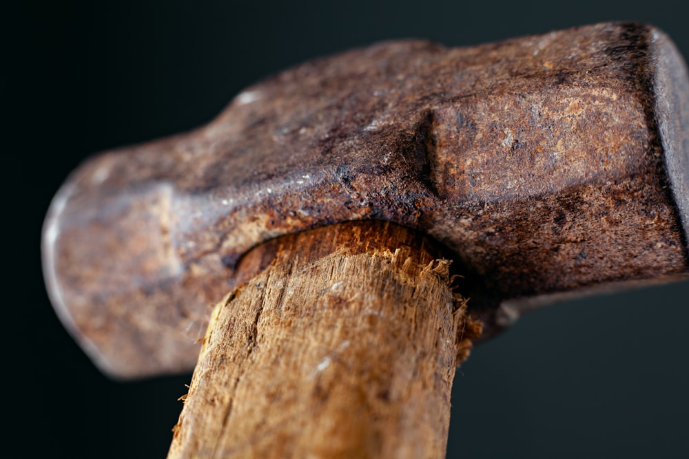a close up of a hammer hitting a piece of wood