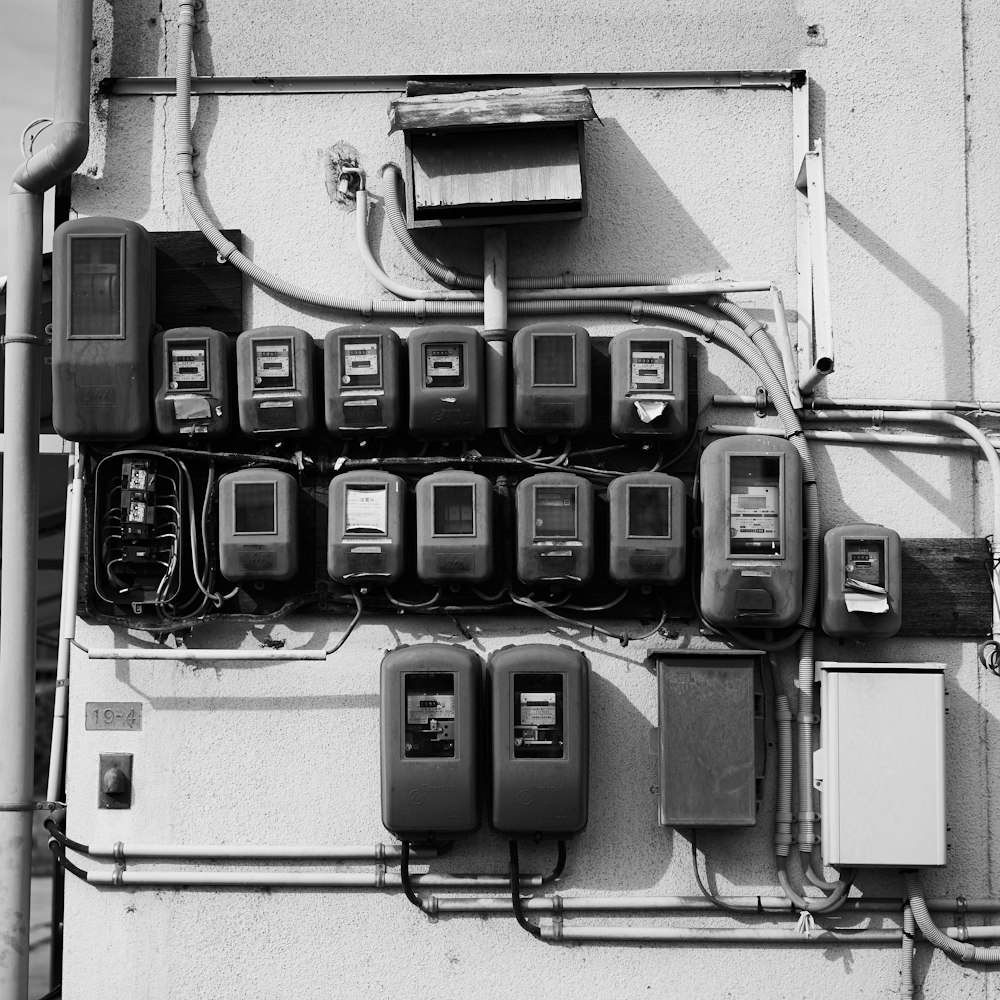 a bunch of old fashioned telephones on a wall