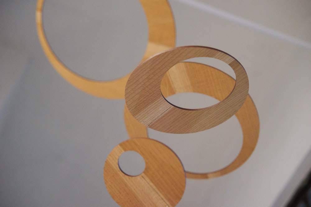 a group of wooden circles hanging from a ceiling