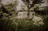 A family enjoying a sunny afternoon outside their spacious caravan with outdoor seating.