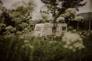 A family enjoying a sunny afternoon outside their spacious caravan with outdoor seating.