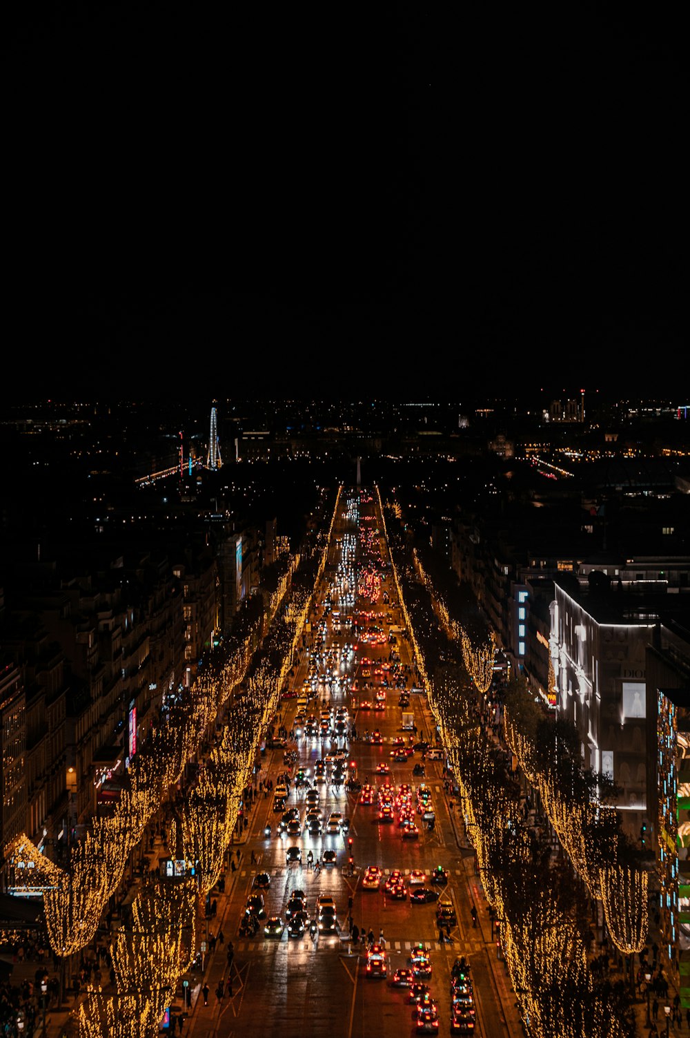 a city street filled with lots of traffic at night