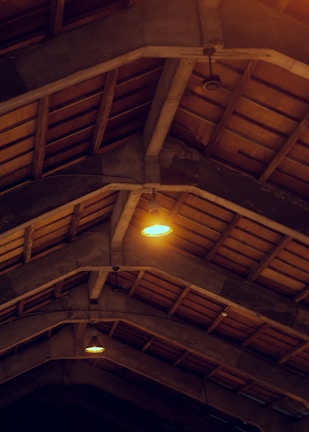 Interior view of Le Ranch showing historic wooden beams and colorful modern accents.