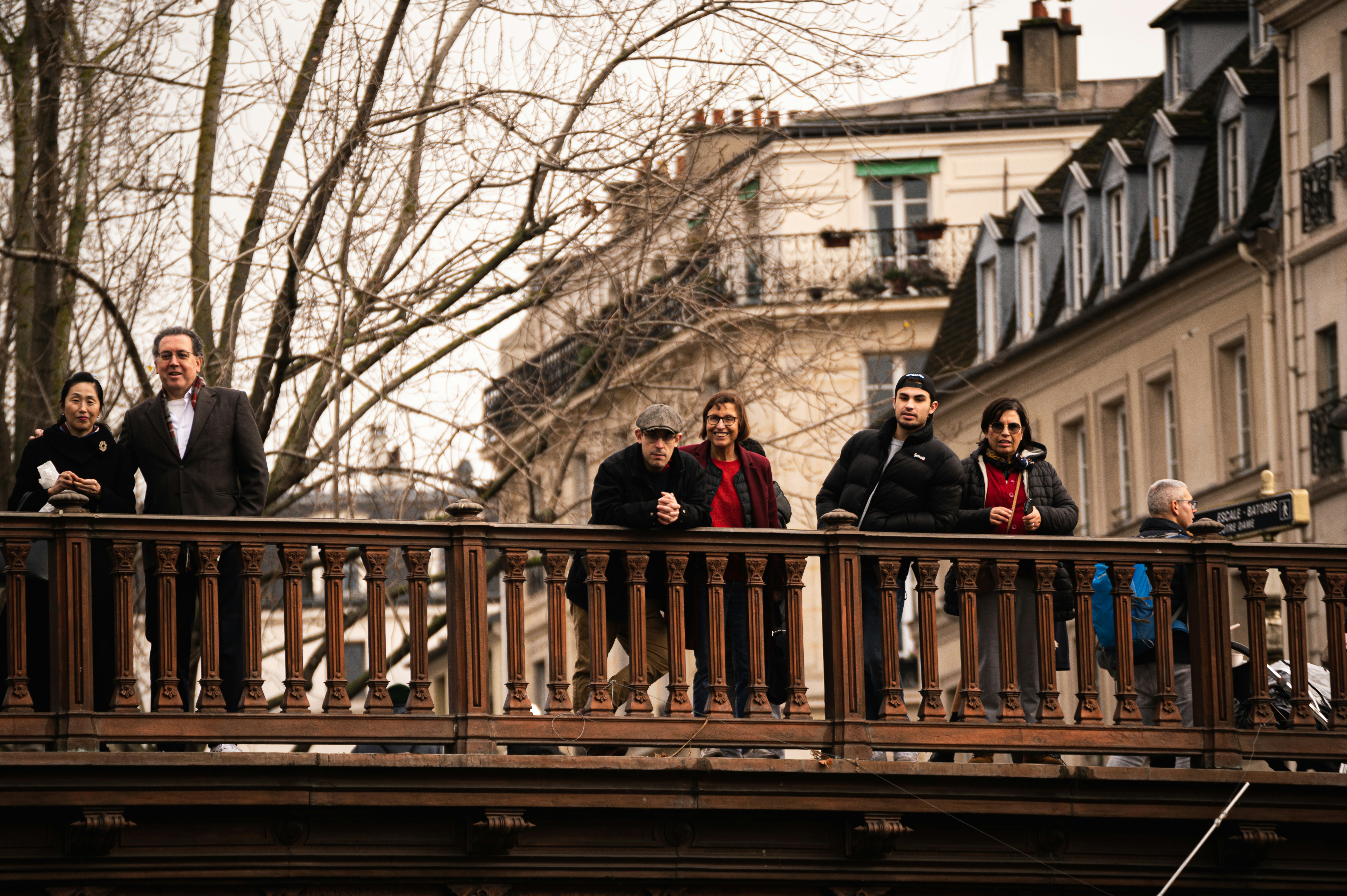 a group of people standing on top of a bridge