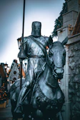 Close-up of the Knight of Pentacles astride a sturdy horse, holding a pentacle firmly.