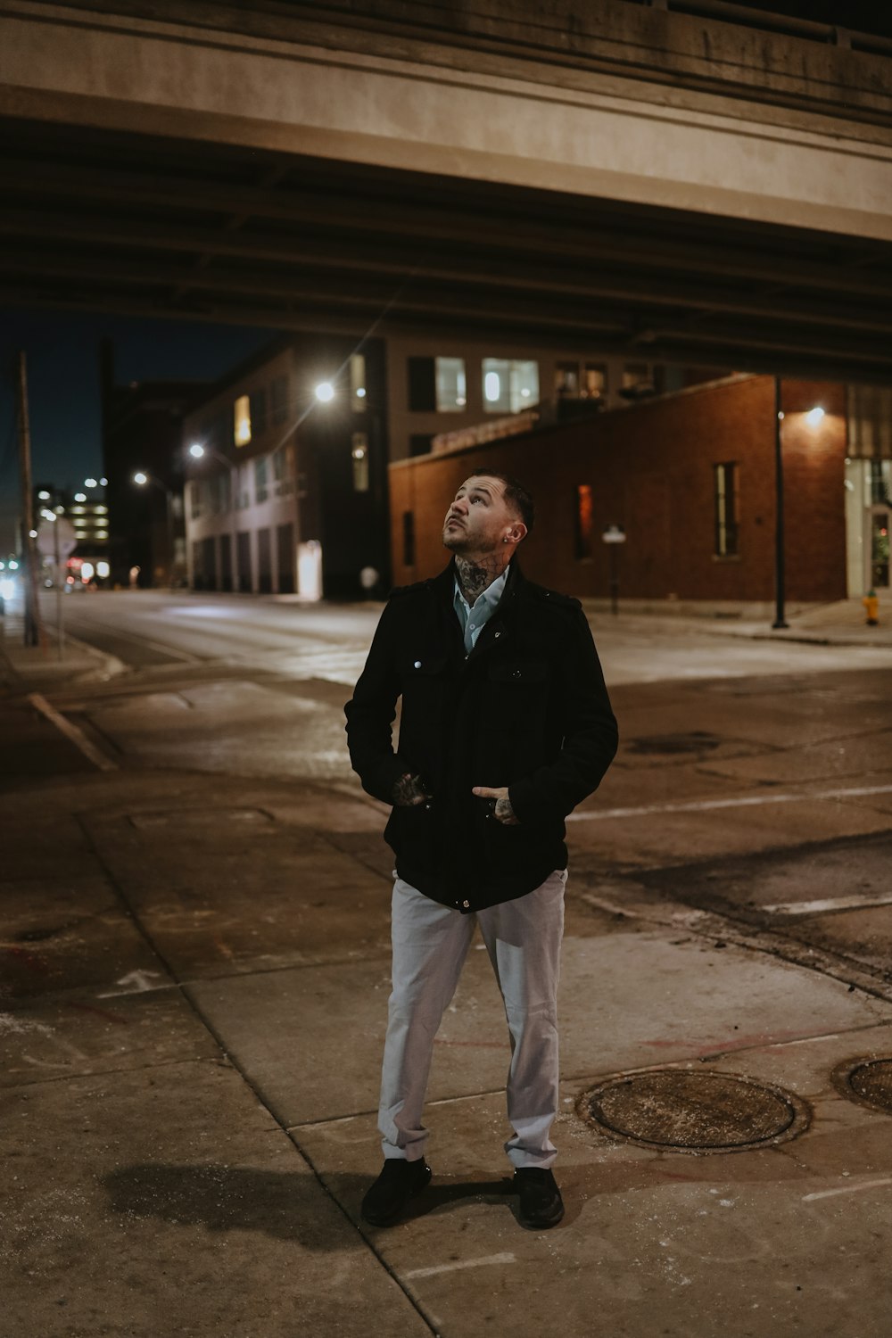 a man standing on a sidewalk in front of a building