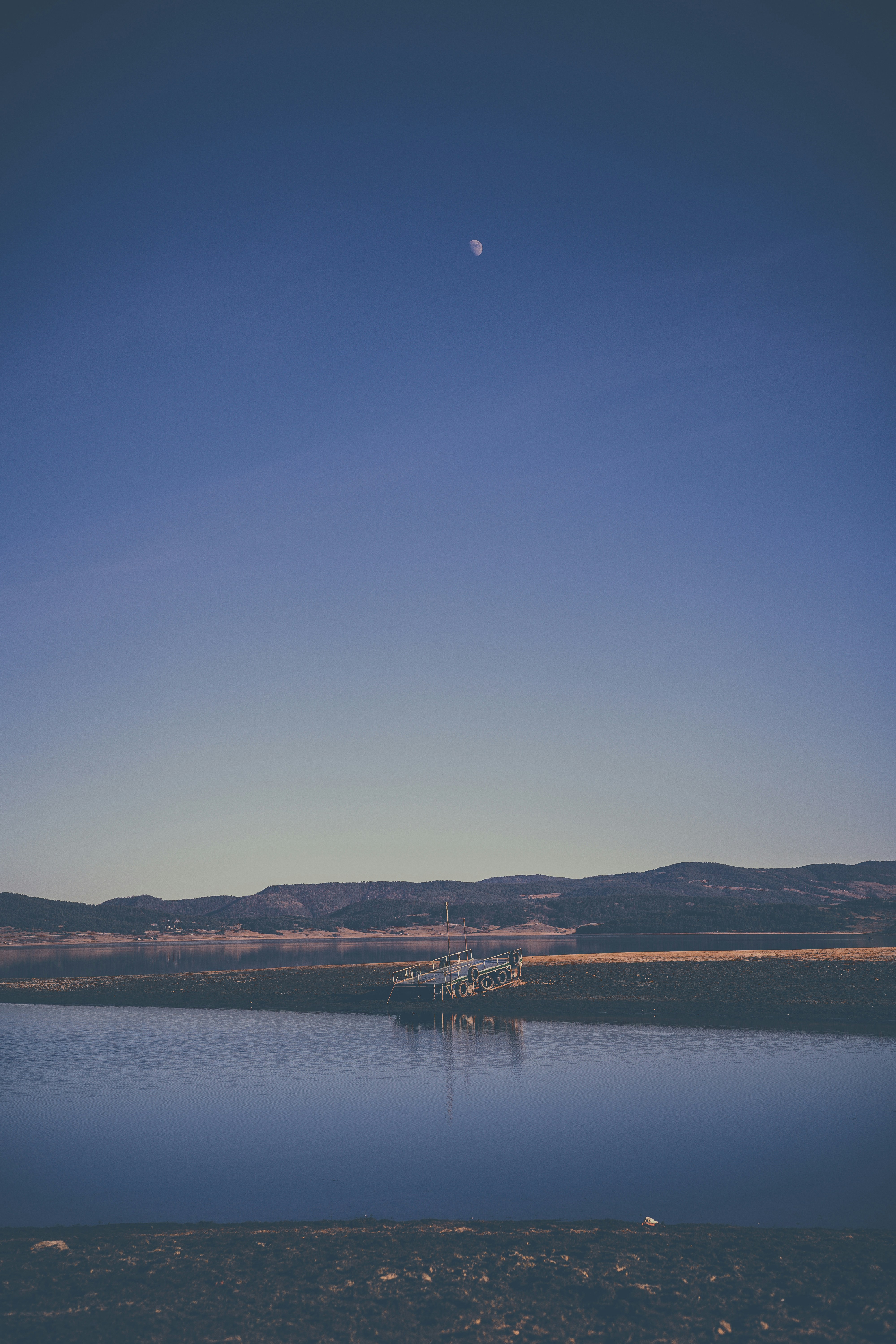 a large body of water with a boat in the distance