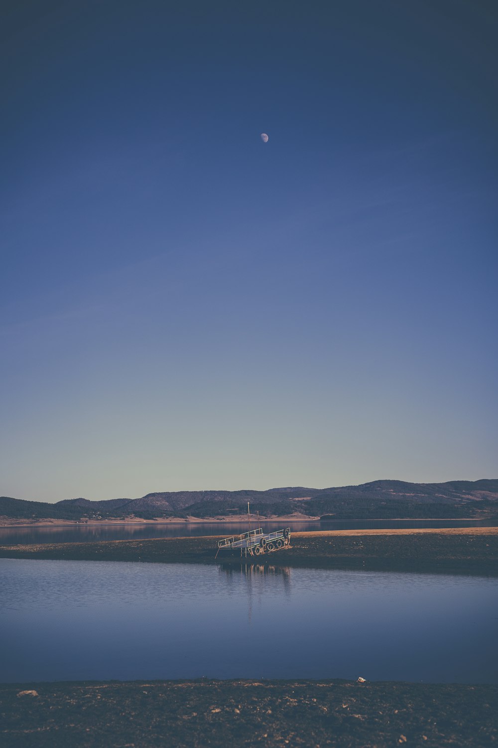 a large body of water with a boat in the distance