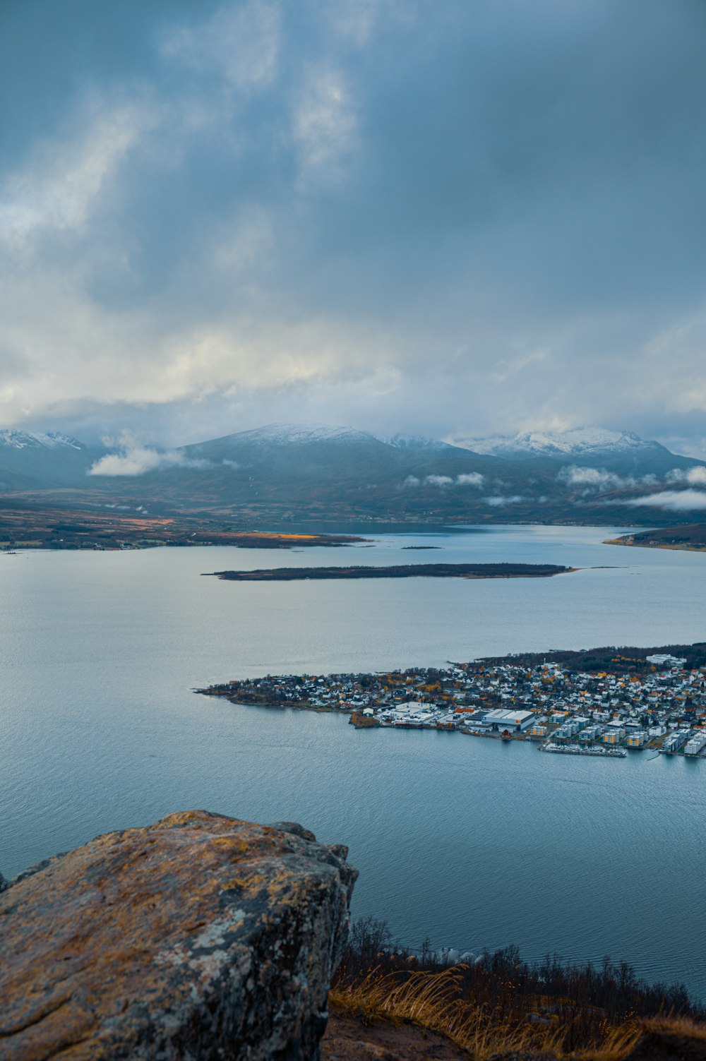 a view of a large body of water with mountains in the background