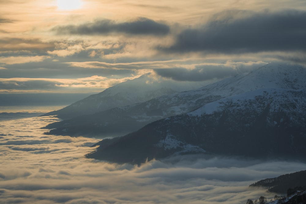 a view of a mountain covered in clouds