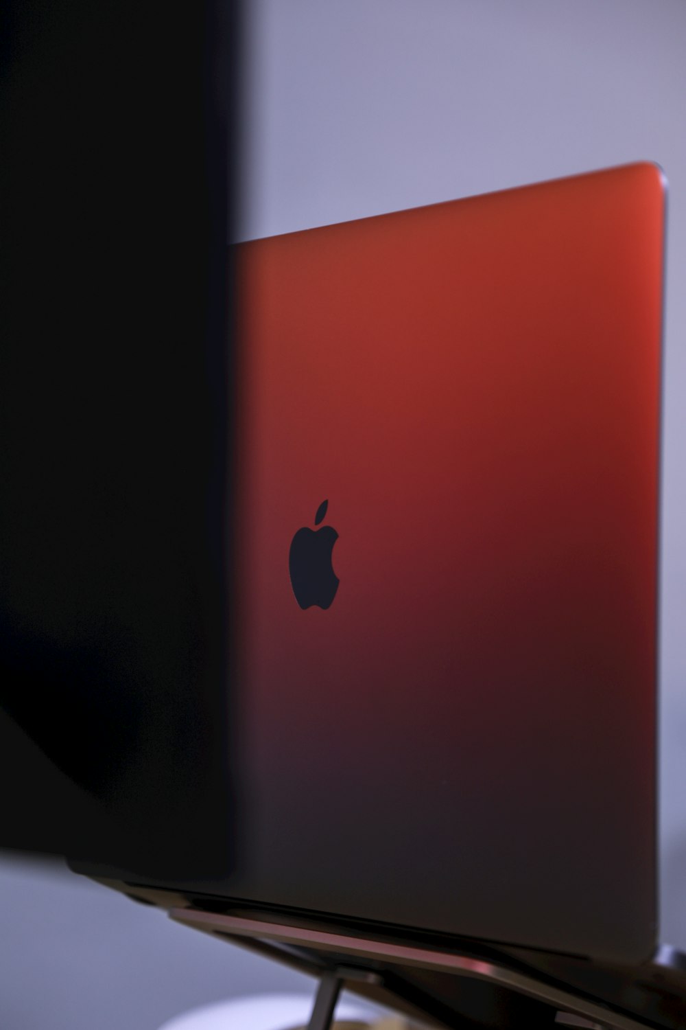 a red apple laptop sitting on top of a table