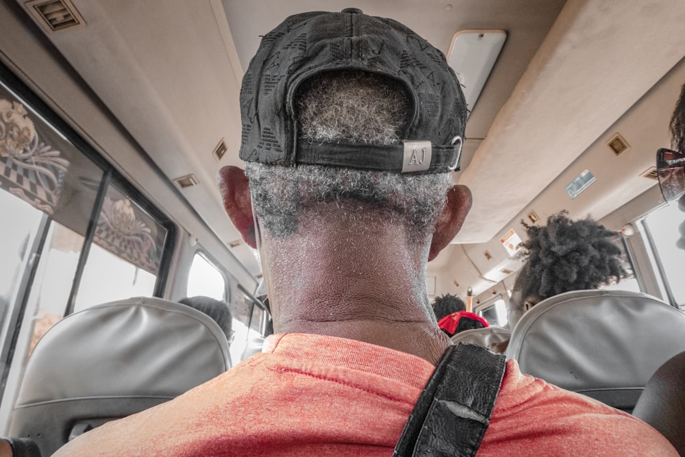 a man with a beard and a hat on a bus