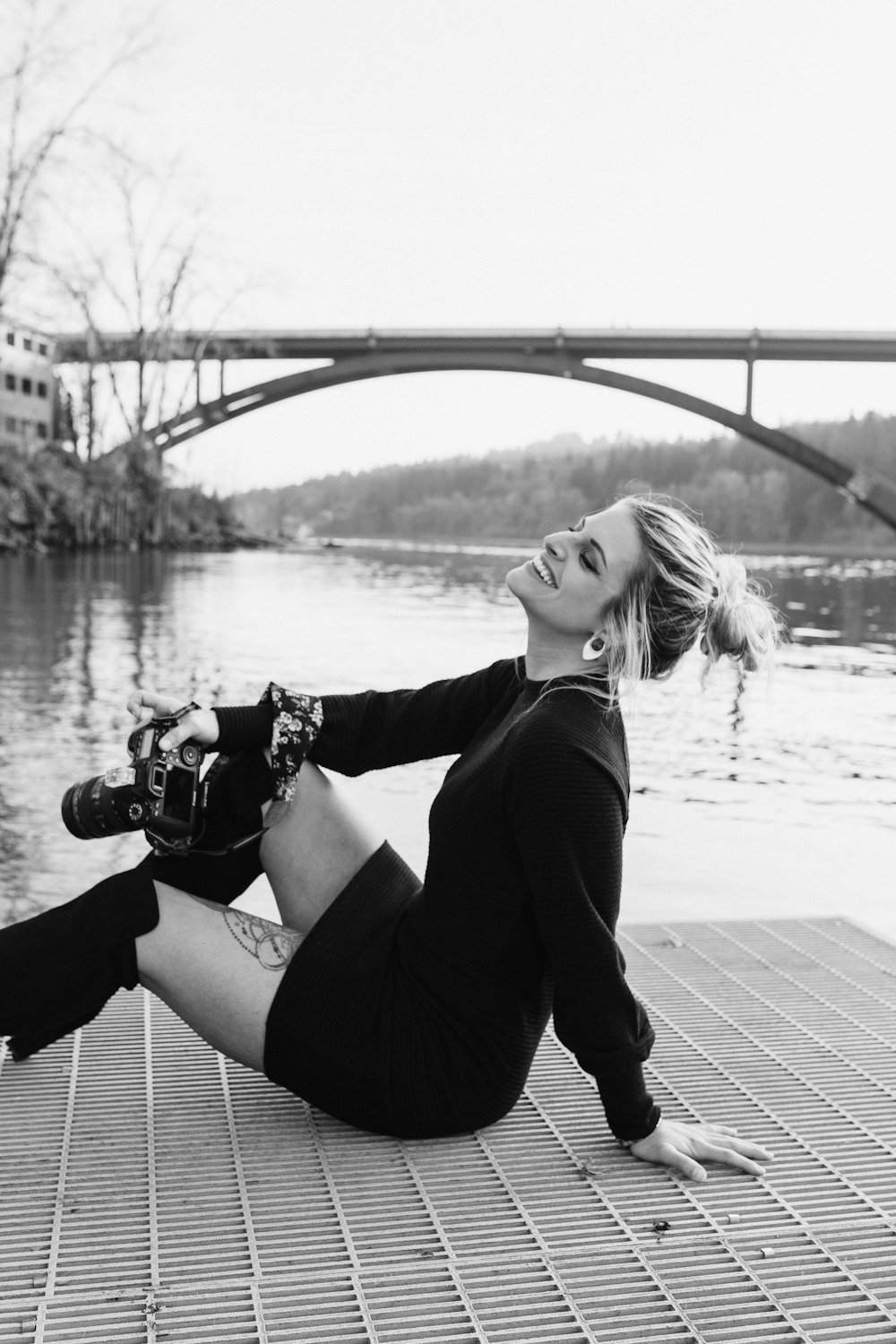 a woman sitting on the ground with a skateboard