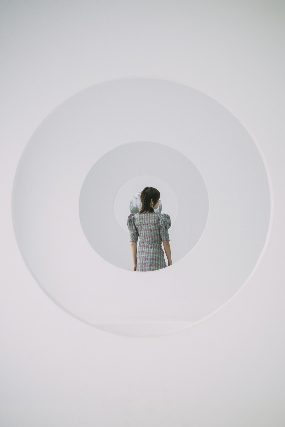 a woman standing in a white circle with her back to the camera