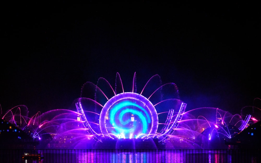 a large ferris wheel lit up at night