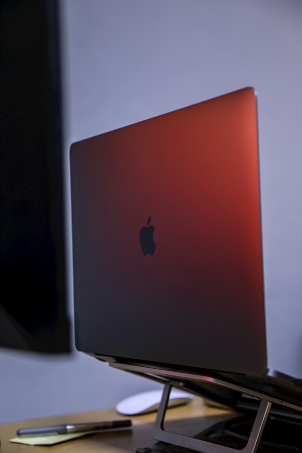 an apple laptop sitting on top of a wooden desk