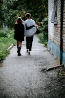 A candid moment of a couple walking hand-in-hand near the clinic entrance.