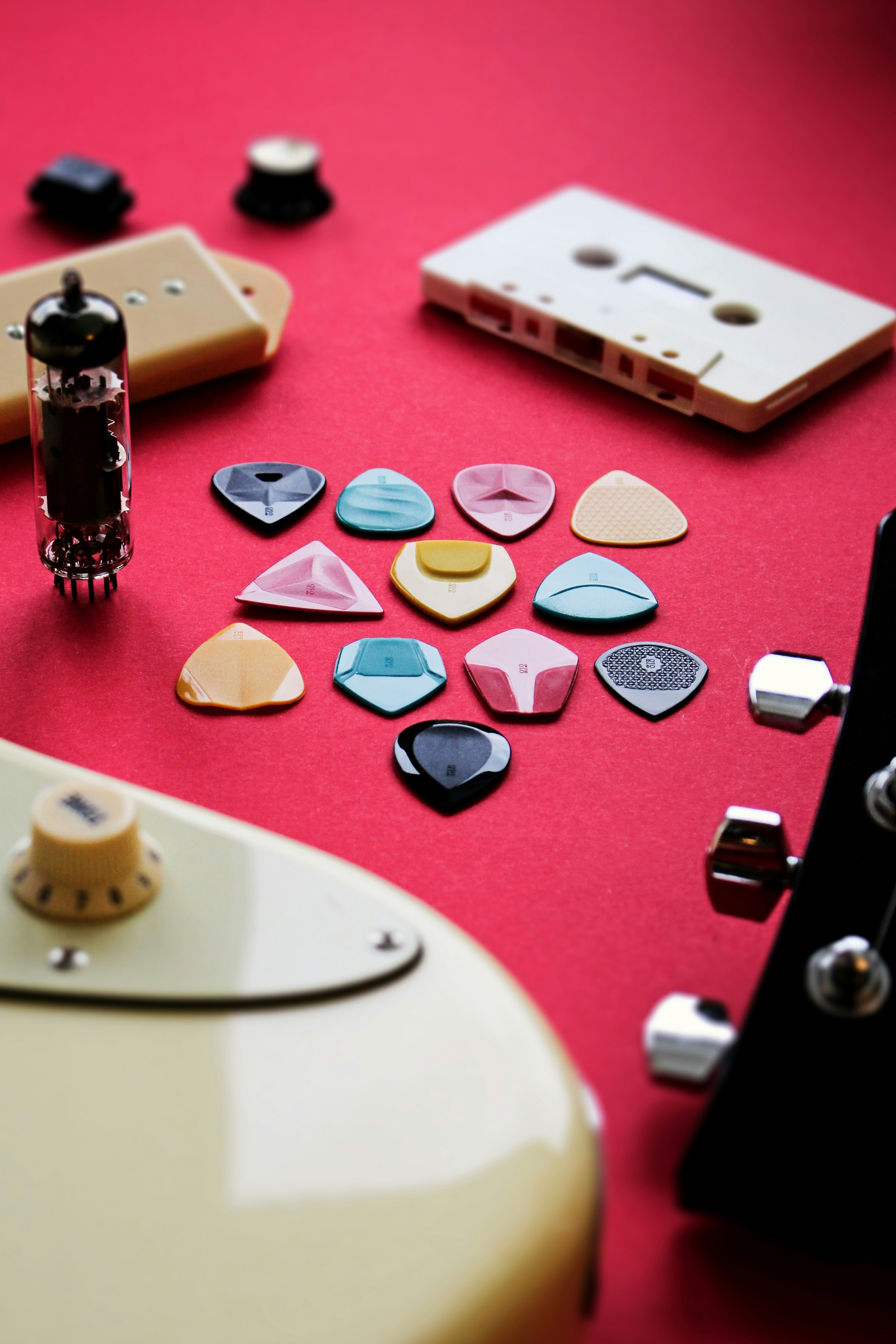 a group of guitar picks sitting on top of a red table