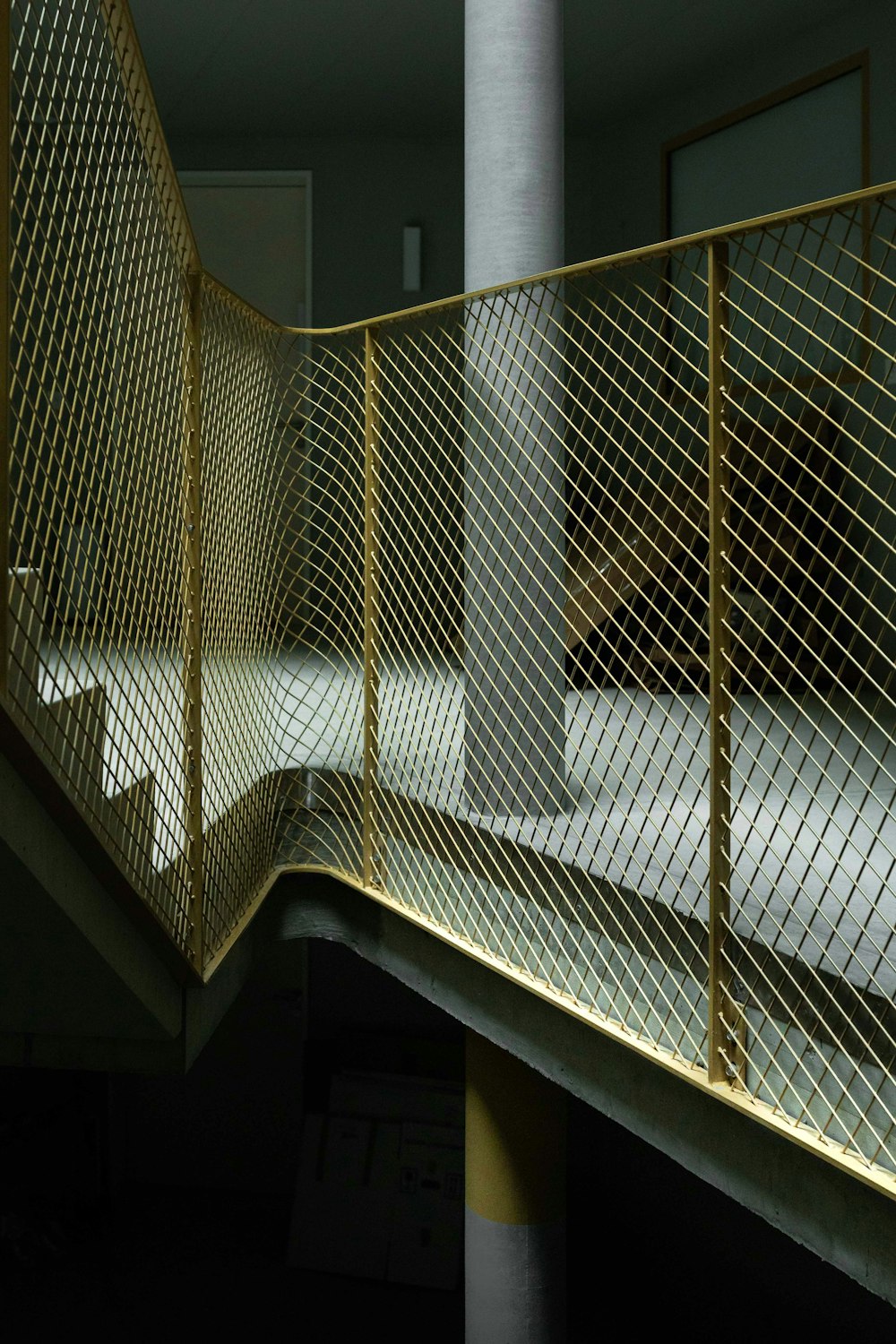 a metal stair railing with a person walking up it