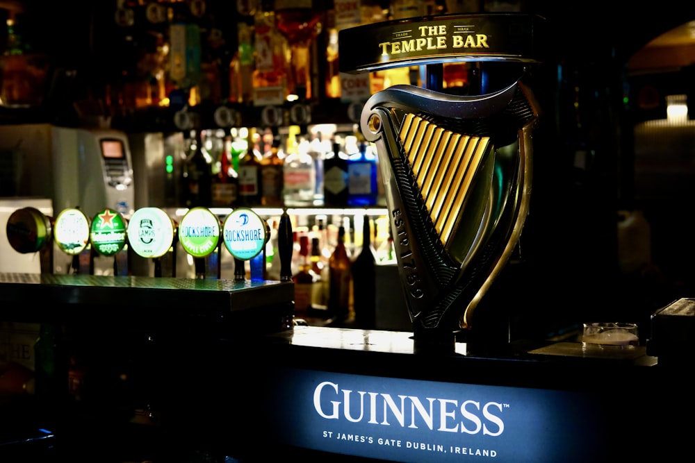 a guinness glass sitting on top of a bar