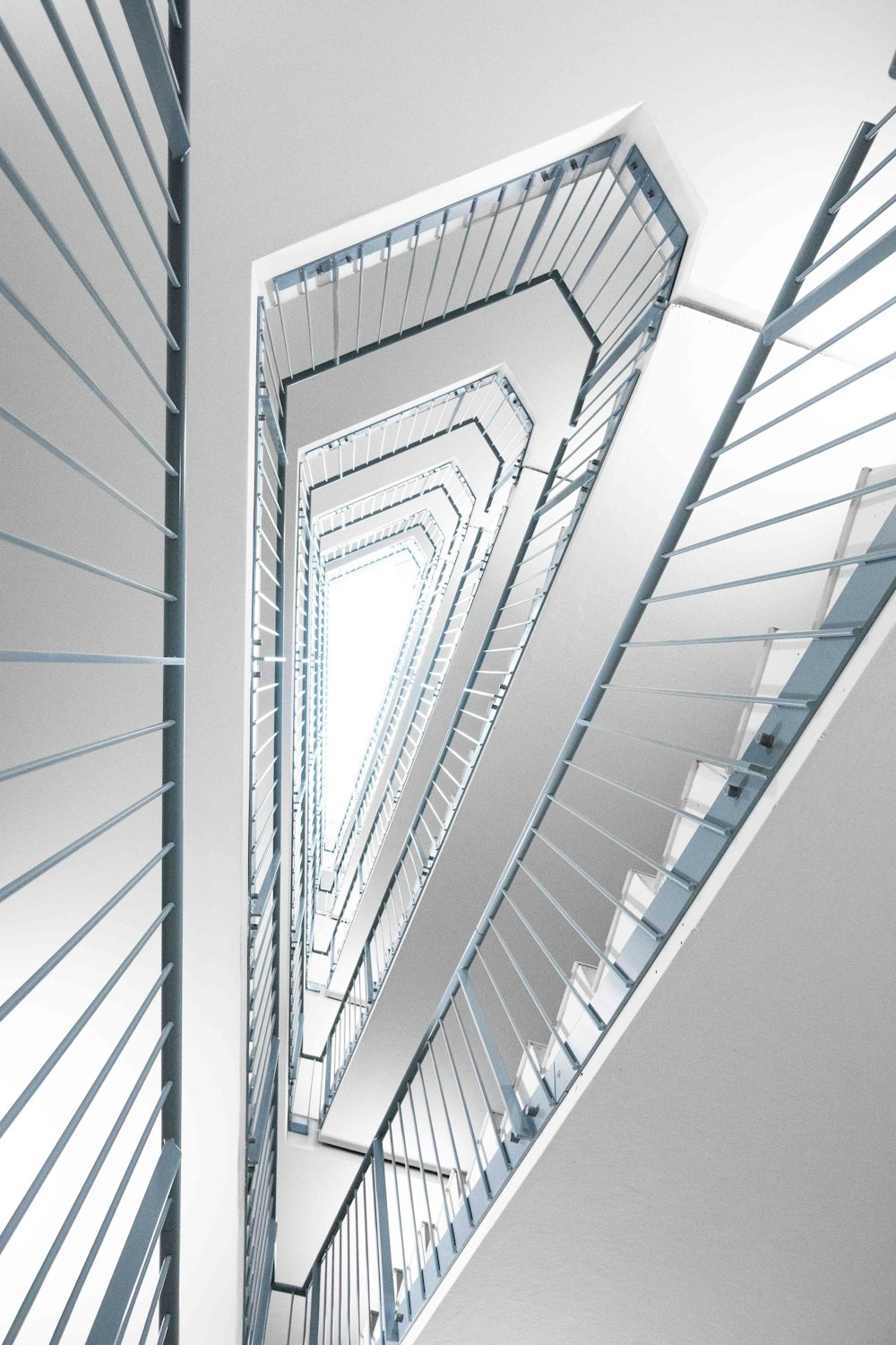 a spiral staircase in a building with a skylight