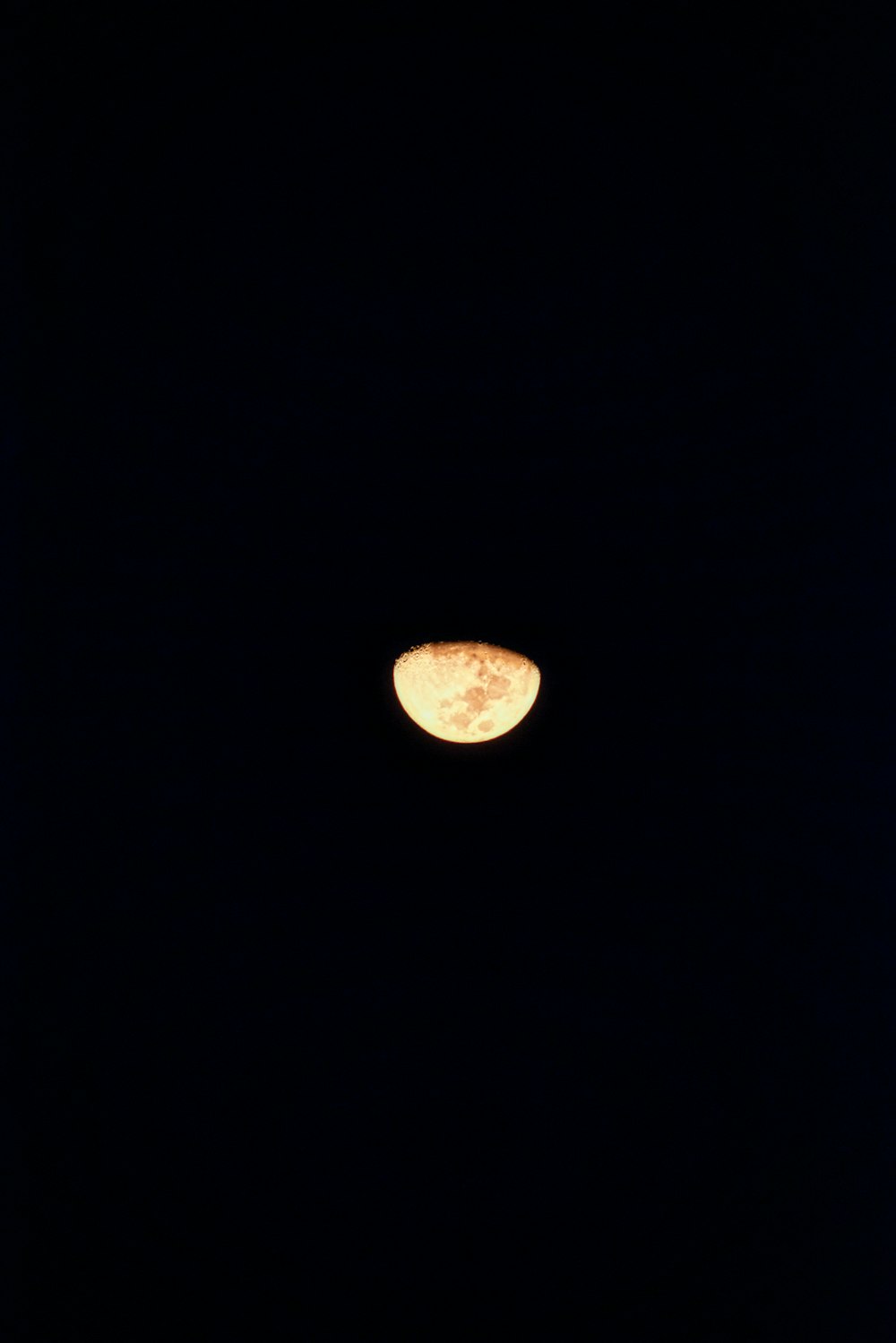 a full moon seen through the dark night sky