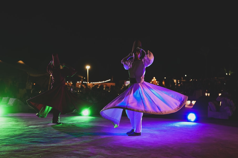 a couple of people standing on top of a dance floor