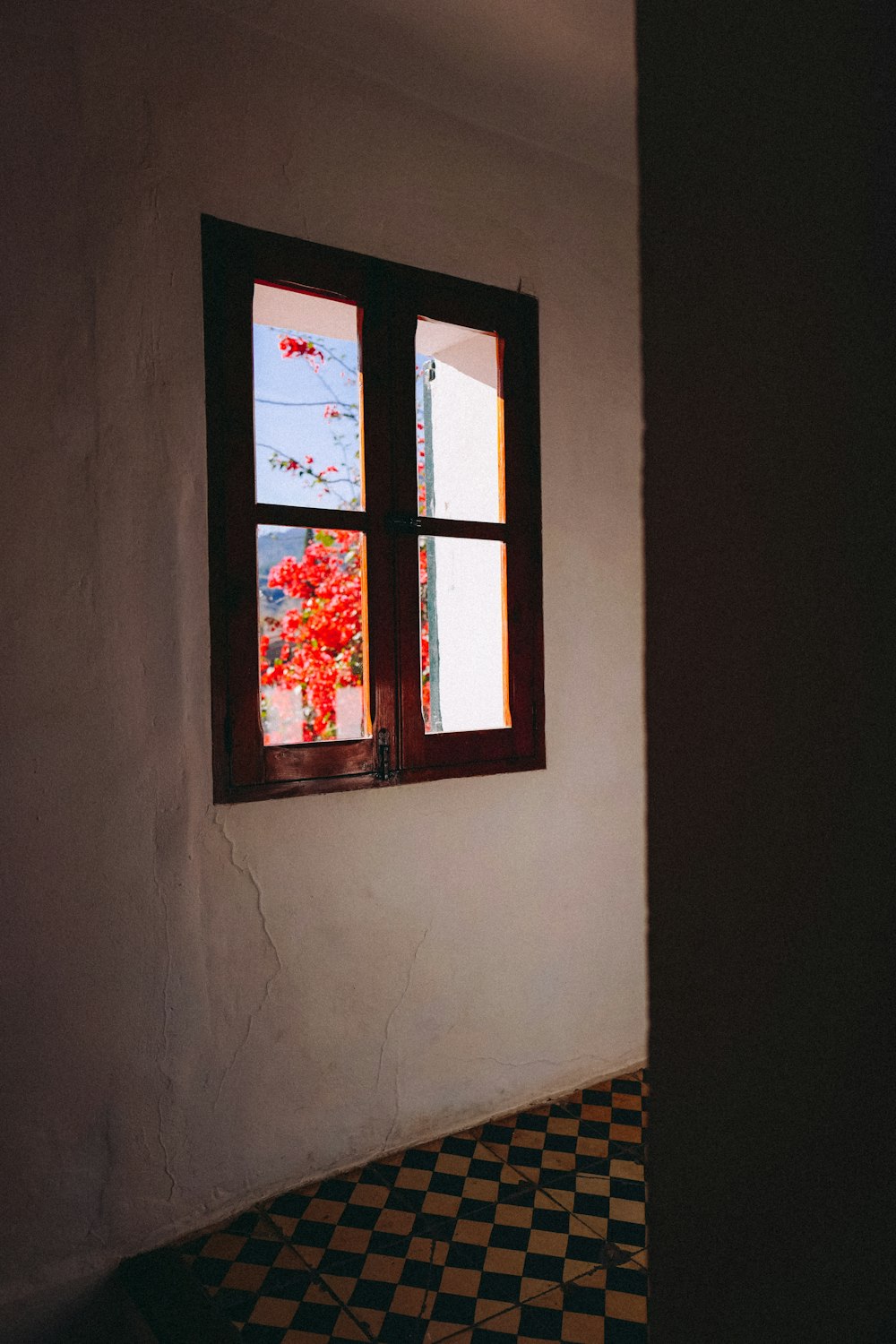 a room with a checkered floor and a window