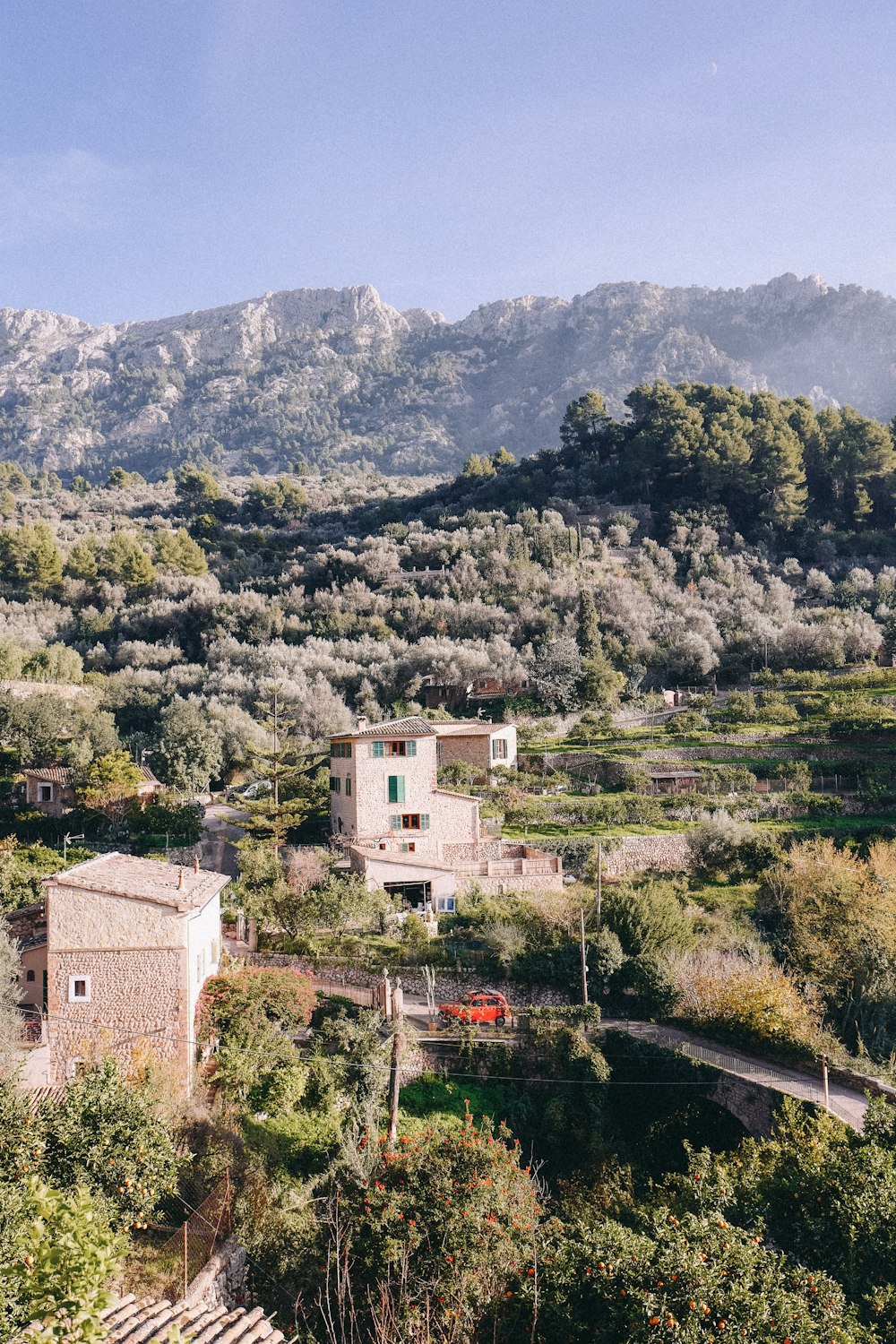 a house in the middle of a lush green hillside