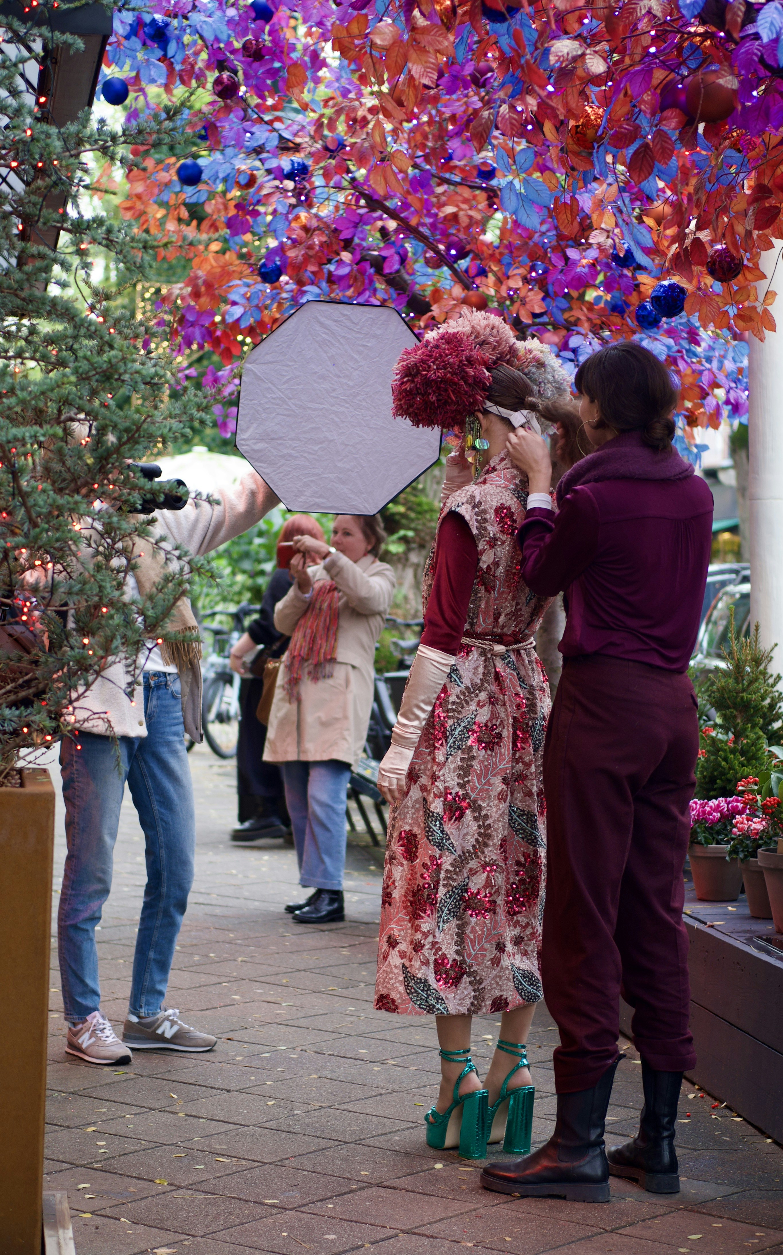 a couple of people that are standing under a tree