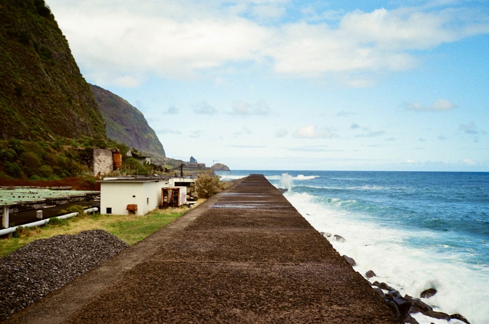 a long road next to a body of water