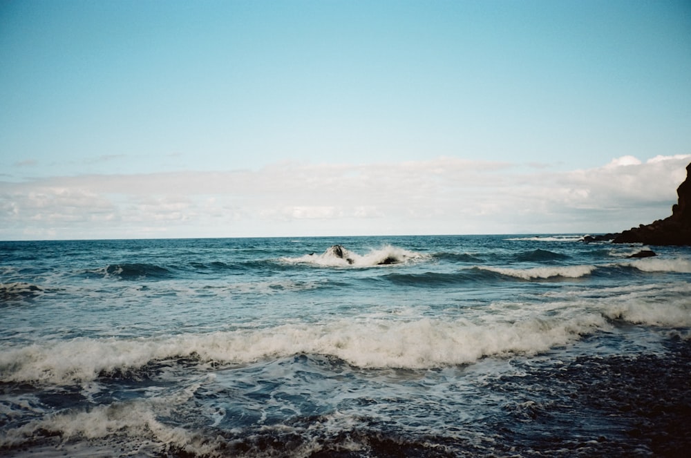 a person riding a surfboard on a wave in the ocean