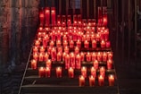 a group of red candles sitting on top of a set of steps
