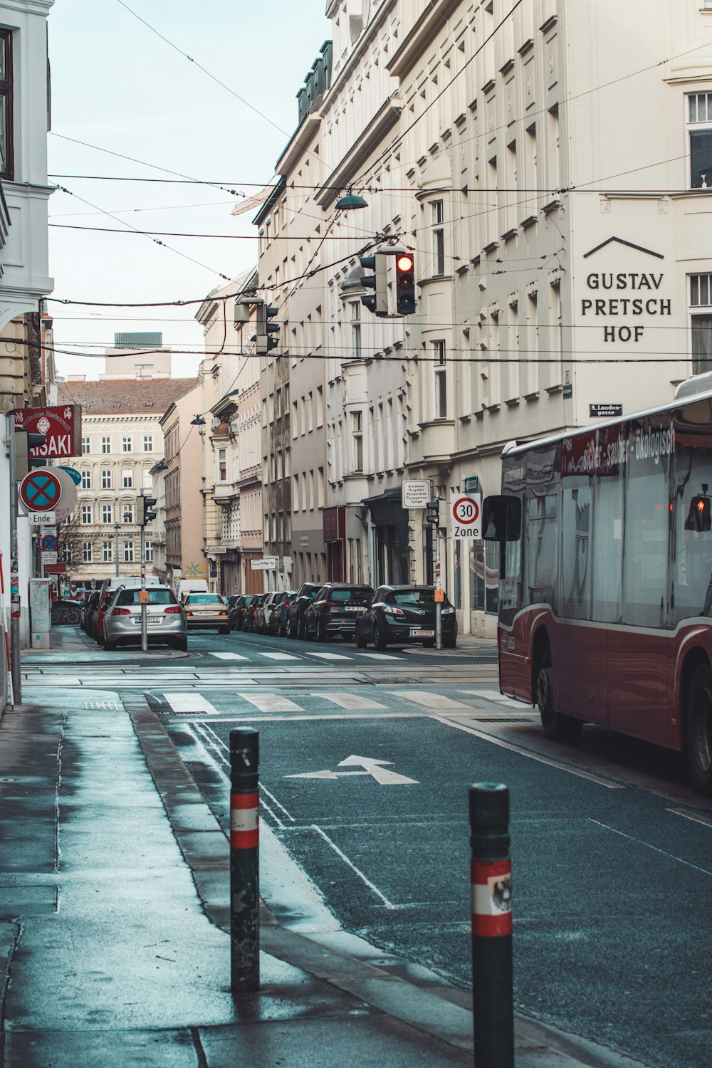 a city street filled with traffic next to tall buildings