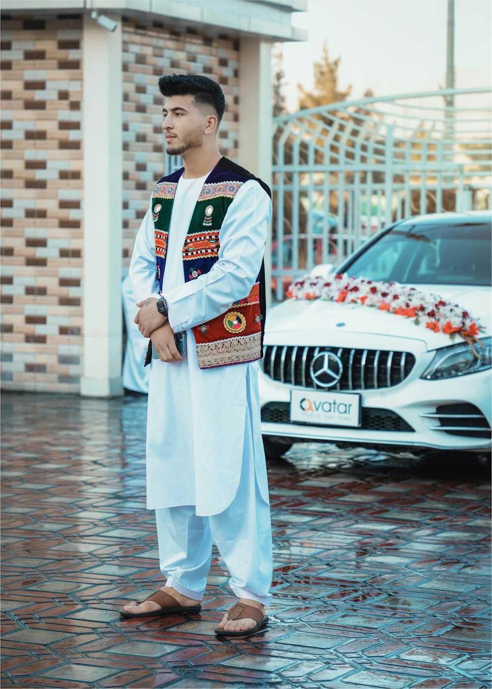 a man standing in front of a white car