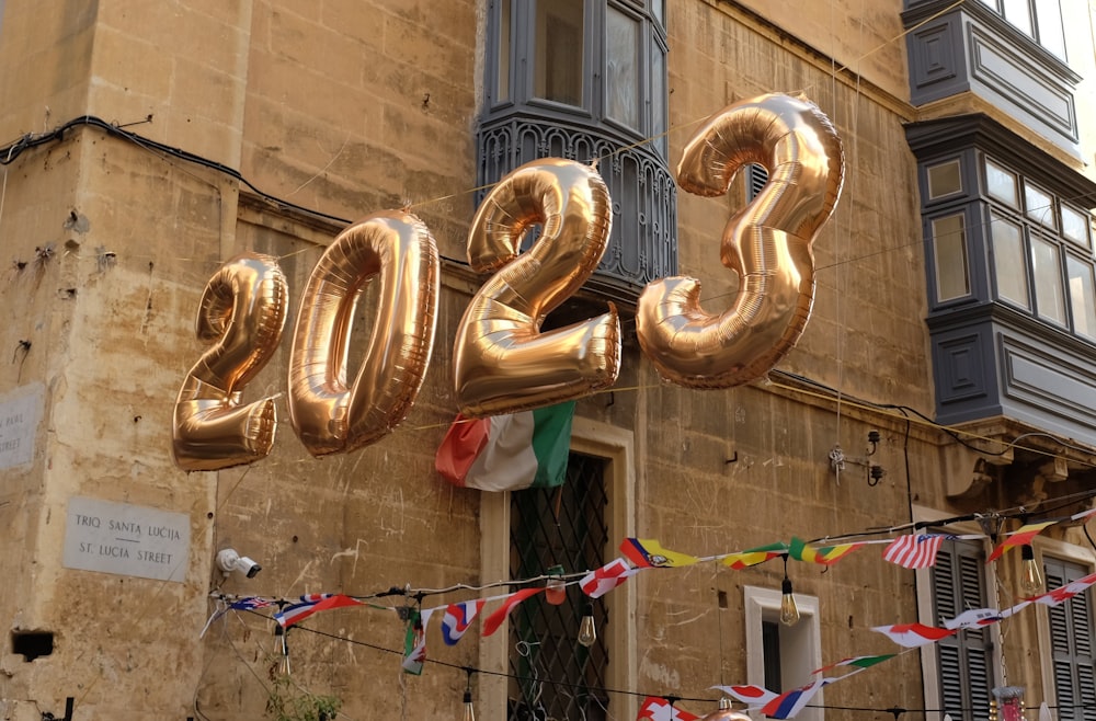 a large balloon in the shape of a number hanging from a building