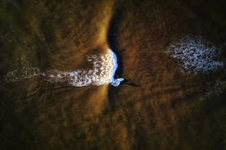 a person riding a wave on top of a surfboard