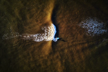 a person riding a wave on top of a surfboard