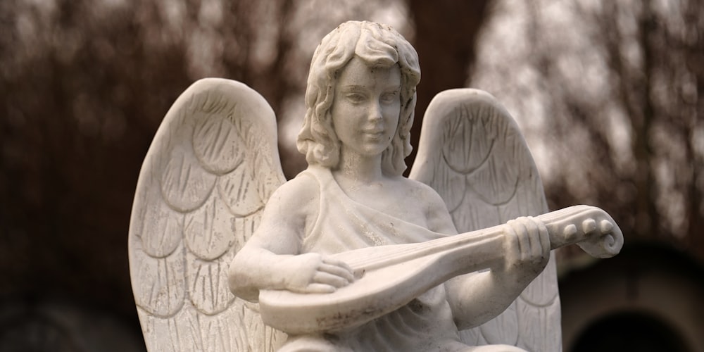 a statue of an angel holding a guitar