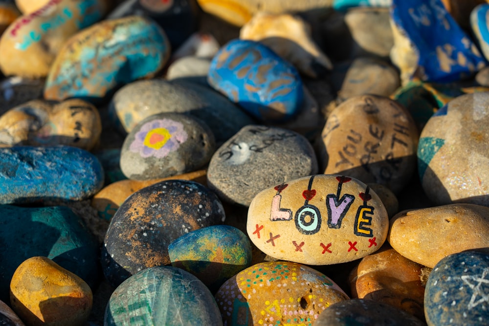 a pile of rocks with the word love painted on them
