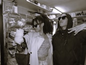 Smiling customers trying out sports equipment in a friendly store environment.