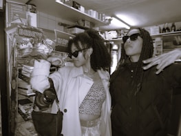 Smiling customers trying out sports equipment in a friendly store environment.