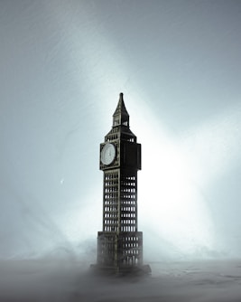 a clock tower in the middle of a foggy sky