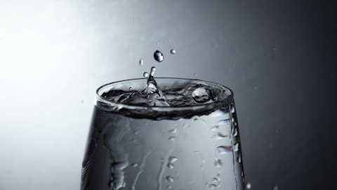 a glass filled with water on top of a table