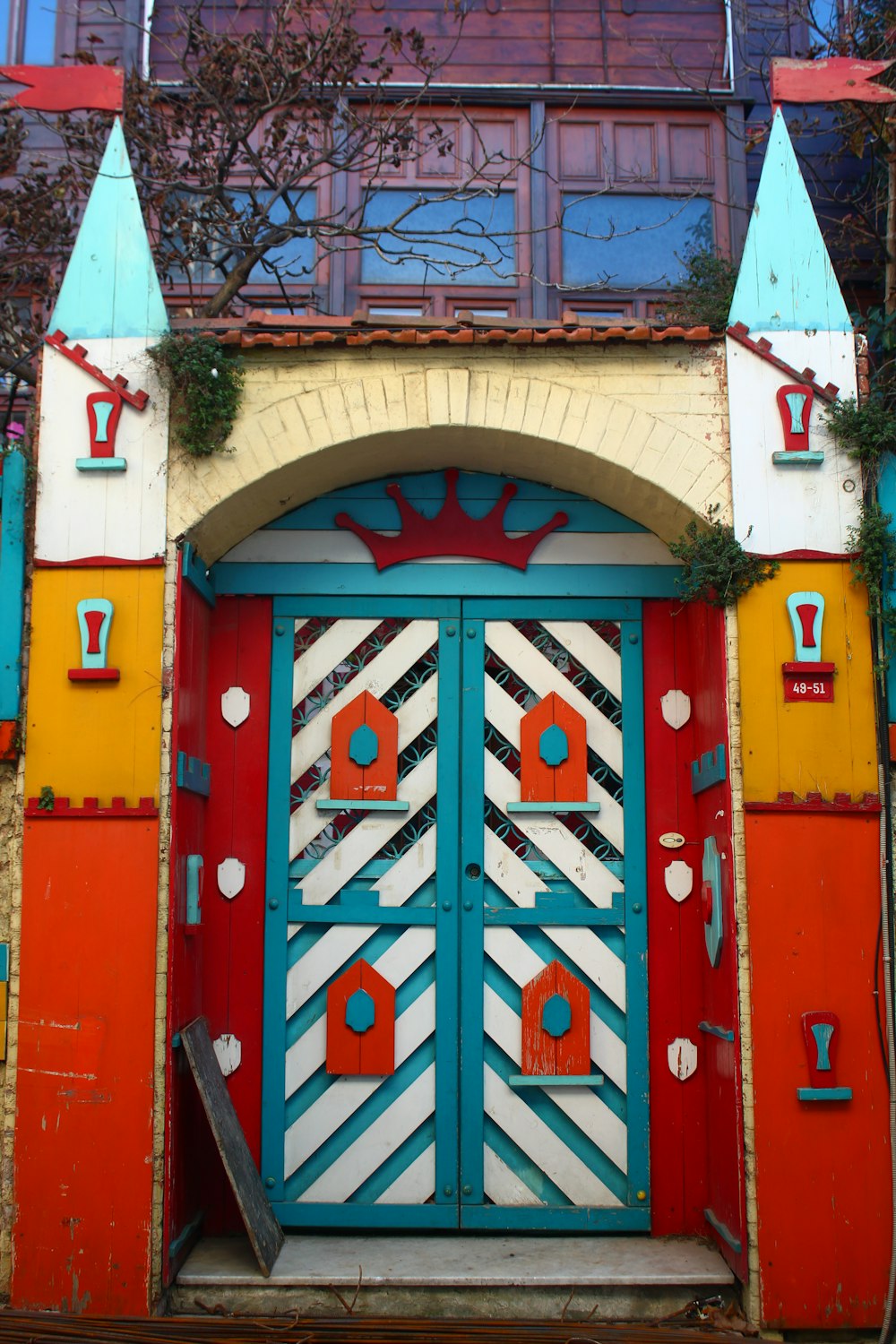 a colorful building with a large blue door