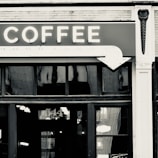 Close-up of a vintage sign hanging above a cozy coffee shop in Old City.