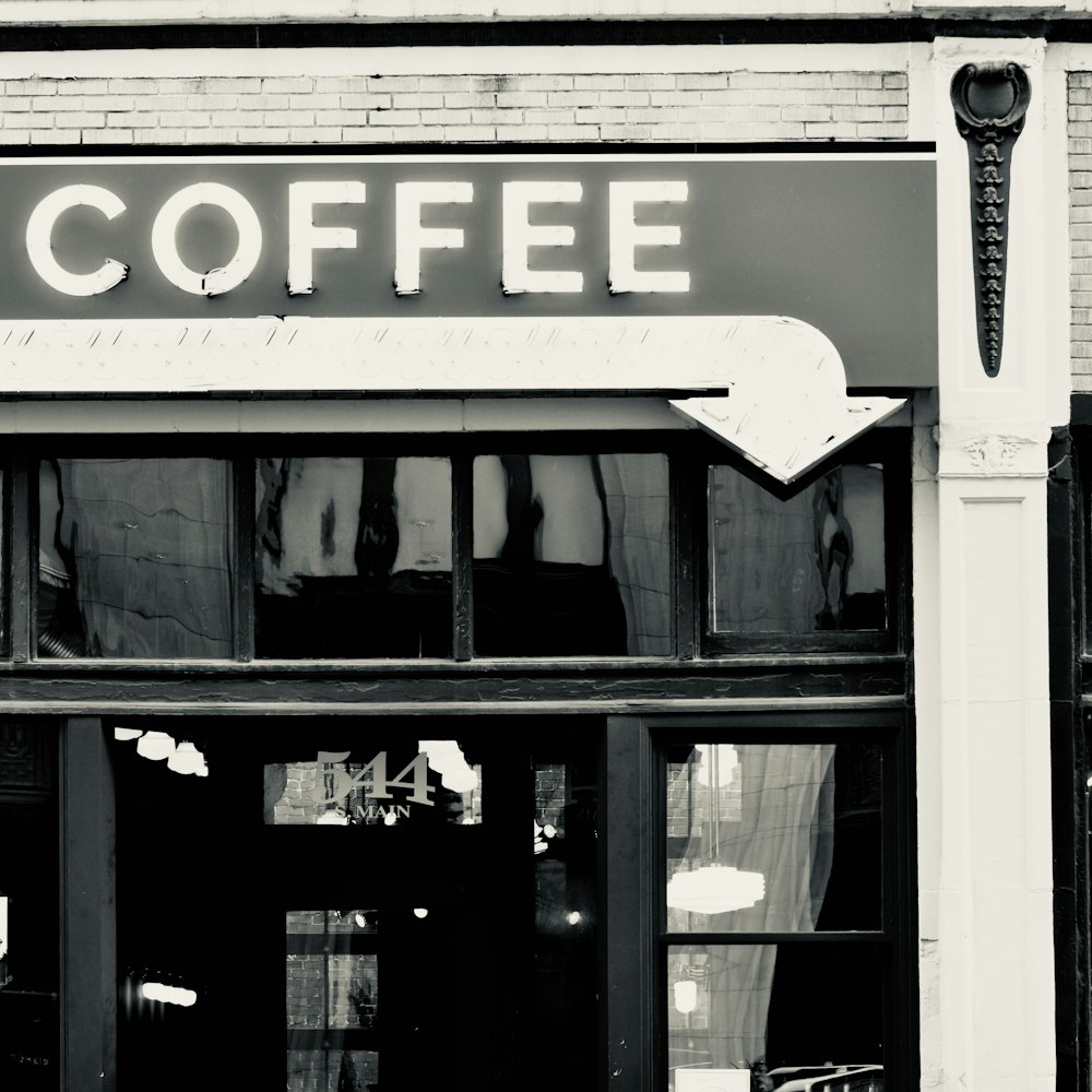 a black and white photo of a coffee shop