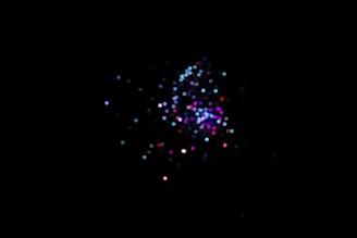 Graphical representation of data clusters on a screen, glowing softly in a dark room.