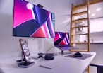 a desk with a laptop and a monitor on it