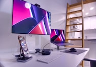 a desk with a laptop and a monitor on it